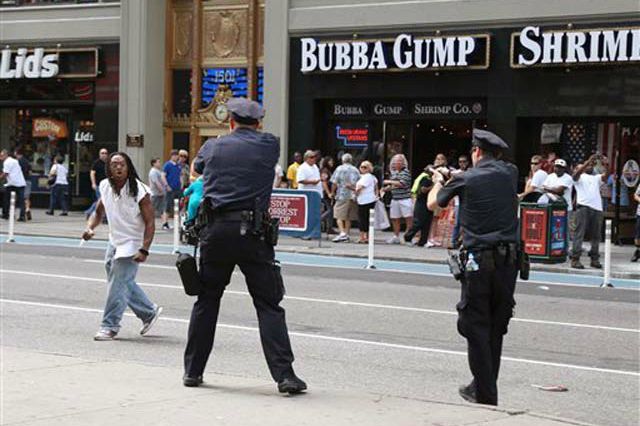 NYPD officers confront an emotionally disturbed man brandishing a knife in Times Square in 2012, moments before shooting him dead.